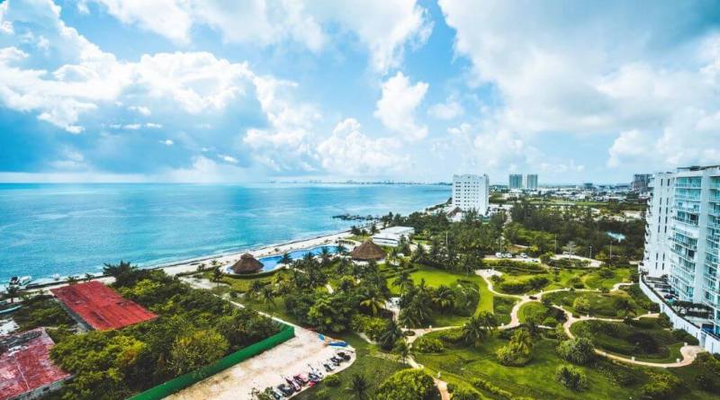 aerial view of trees and pools near the beach in Cancun