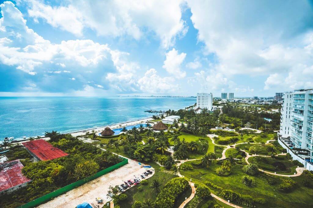aerial view of trees and pools near the beach in Cancun